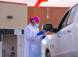 (Leah Hogsten  |  The Salt Lake Tribune) Brenda Vijil, a Diné  medical assistant at Utah Navajo Health System's Monument Valley Clinic, records an incoming patient's personal information waiting in their vehicle before admittance into the triage unit to take vitals and administer a coronavirus test, Aug., 24, 2020.
